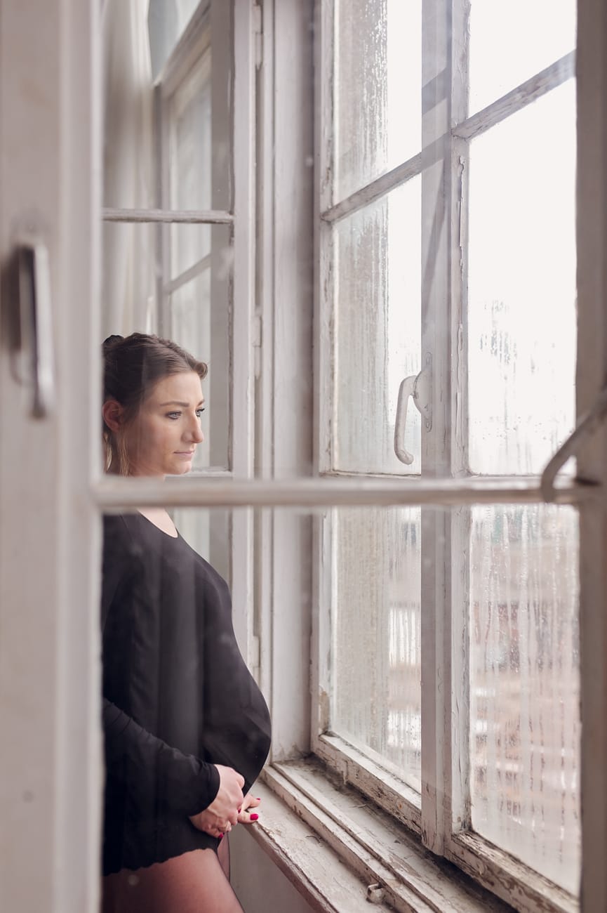 Mama w ciąży przy oknie panorama stoczni sesja Gdańsk