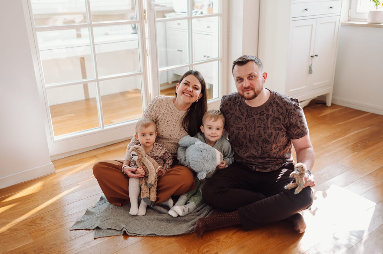 Rodzina bawi się na podłodze sesja w domu Sopot