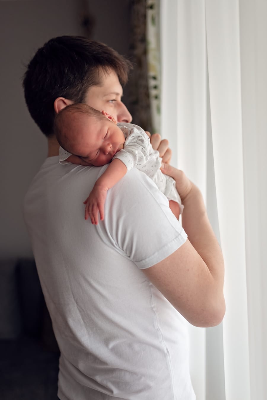 Noworodek śpi na ramieniu taty naturalne światło Gdańsk