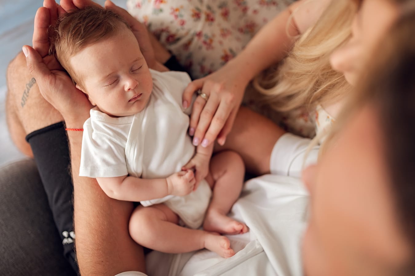 Niemowlę śpi na kolanach taty sesja w domu Gdańsk