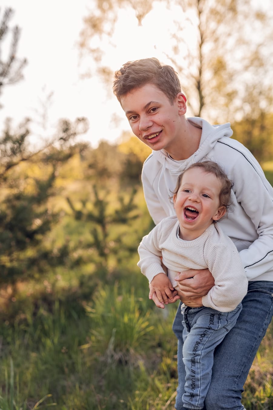 Rodzeństwo bawi się na łące sesja rodzinna Gdynia