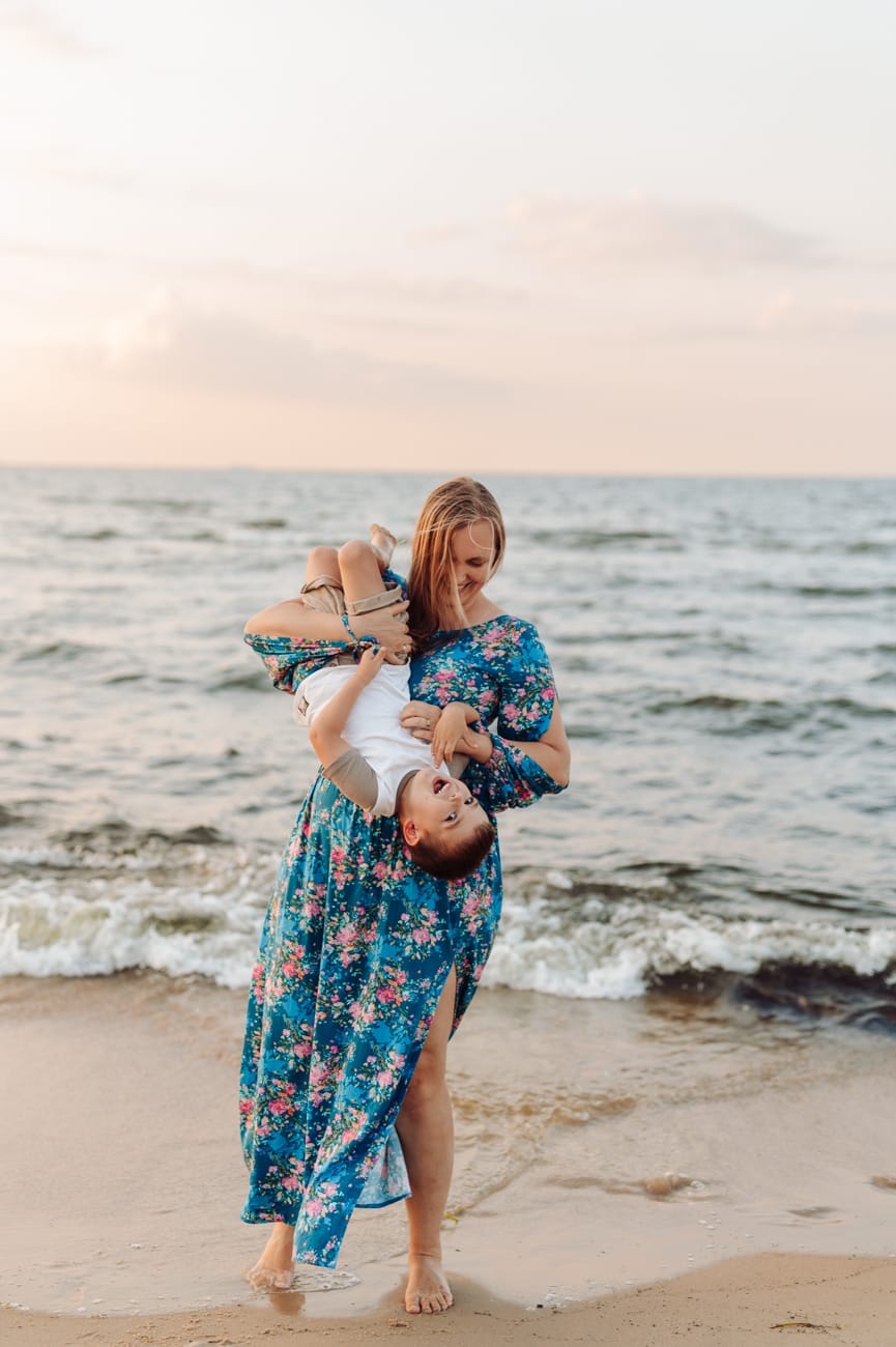 Mama z synem zabawy na plaży zachód słońca